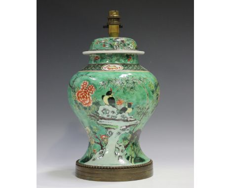 A Chinese famille verte enamelled porcelain vase and cover, late Qing dynasty, the baluster body painted with birds perched o