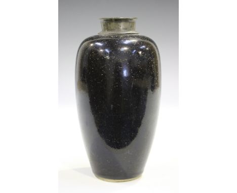 A Chinese black glazed porcelain vase, Kangxi period, of elongated ovoid form beneath a pewter mounted neck, unmarked, height