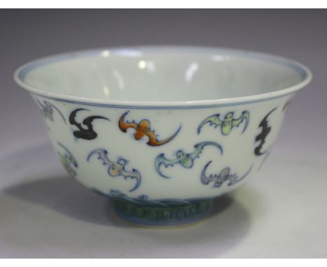 A Chinese doucai porcelain bowl, mark of Kangxi but 20th century, the exterior painted with bats flying above waves, undergla