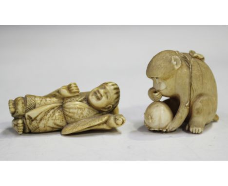 A Japanese carved ivory okimono netsuke, Meiji period, modelled in the form of a seated monkey, incised and stained two-chara