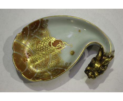 A Chinese iron red and gilt decorated porcelain dish, mark of Qianlong but modern, the scalloped shallow dish painted with a 