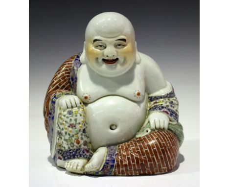 A Chinese famille rose enamelled porcelain figure of a smiling Buddha, probably 20th century, modelled seated wearing an open