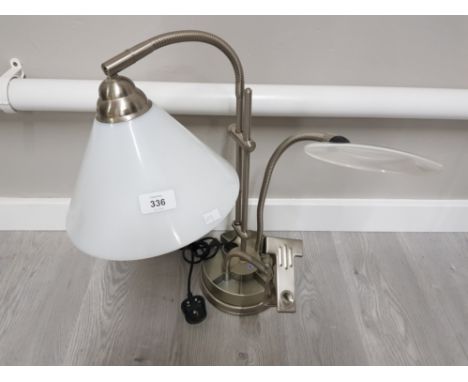 A METAL READING LAMP WITH MAGIFYING GLASS AND CLIP
