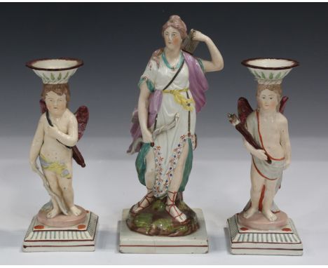 A pair of Staffordshire pearlware pottery candlestick figures, circa 1790-1810, modelled as Cupid with his bow, a quiver of a