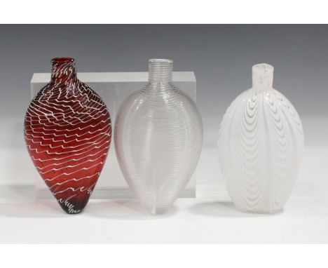 Three Nailsea Gimmel flasks, late 19th century, the first of compressed teardrop shape, its ruby body with trailed white deco