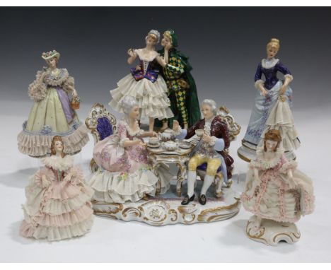 Three Capodimonte porcelain figures, including a courting couple attending a masquerade ball on a gilt scroll decorated base,