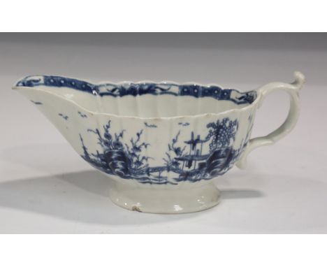 A Worcester blue painted Mission Church pattern sauceboat, circa 1765, of press moulded fluted form, blue painted open cresce