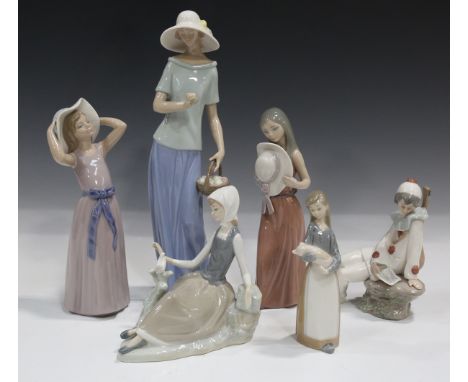 Four Lladro figures, including Bashful, 5007, and Trying on a Straw Hat, 5011, together with a Nao clown and a Nao figure of 