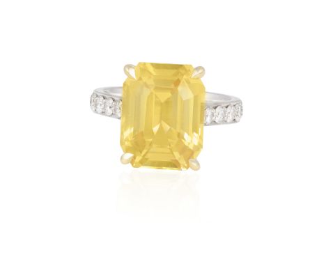 A COLOURED SAPPHIRE AND DIAMOND DRESS RING The cut-cornered rectangular-cut yellow sapphire weighing 11.94cts set in a four-c