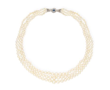 A CULTURED PEARL NECKLACE WITH GEM-SET CLASP The three strands of 3.33mm-7.61mm cultured pearls, to a round-shaped cabochon s