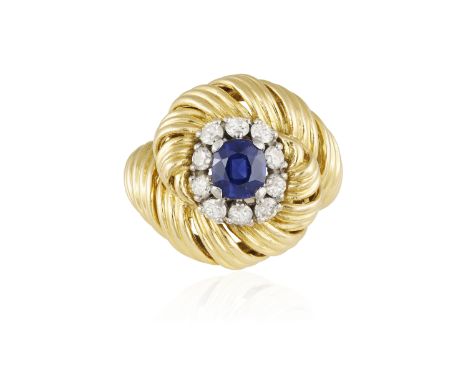 A SAPPHIRE AND DIAMOND COCKTAIL RING, BY BOUCHERON, CIRCA 1960 Of bombé design, the cushion-shaped sapphire centrally set wit