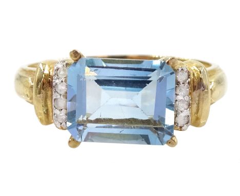 Gold emerald cut blue topaz and diamond ring, stamped 10KCondition Report:Approx 2.25gm, size O