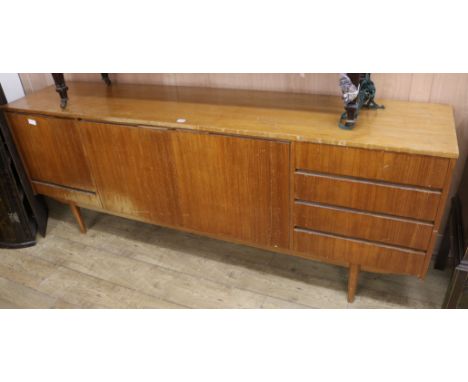A 1950's teak sideboard W.212cm