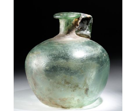 Roman, Imperial Period, ca. 2nd to 4th century CE. A beautiful jug of a sizable form, free-blown from translucent glass of a 