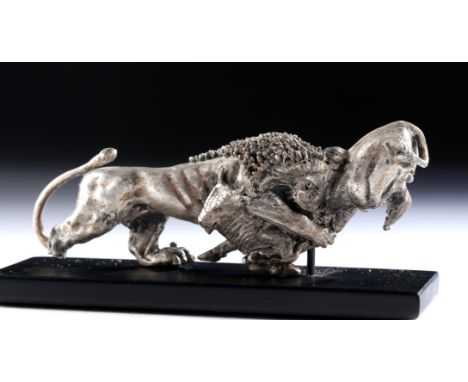 Roman Phoenicia, ca. 1st century BCE. A powerful hollow silver figure, depicting a large lion attacking a bull. The lion is c