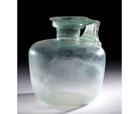Roman, Imperial Period, ca. 2nd to 3rd century CE. A beautiful and finely-preserved jug formed from nearly-transparent glass 
