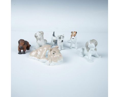 A charming collection of glazed and matte porcelain dog figurines, featuring a bulldog, a pair of cocker spaniels, a Scottish