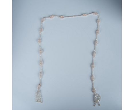 This necklace has white and light pink faux pearls with clear beads. Dimensions: 42"LCondition: Age related wear.