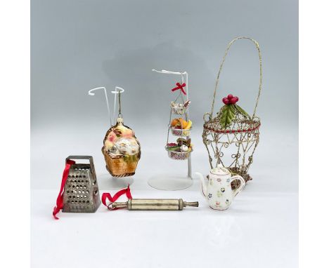 Six ornaments of various materials with a kitchen-related theme. Metal grater, porcelain teapot, metal rolling pin and golden