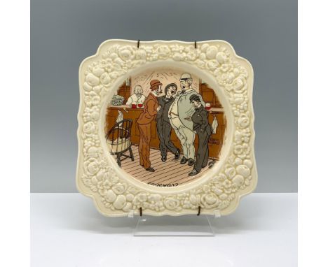 A beige-colored plate adorned with delicate floral relief patterns, featuring a painting depicting a group of men joyfully ga