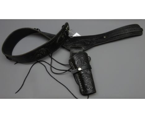 Black leather Mexican single gun rig, belt tooled with scrollwork and chrome buckle, L130cm Condition Report Click here for f