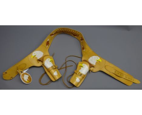 Hand made light brown leather double gun rig, belt tooled and painted with eagles, L122cm Condition Report Click here for fur