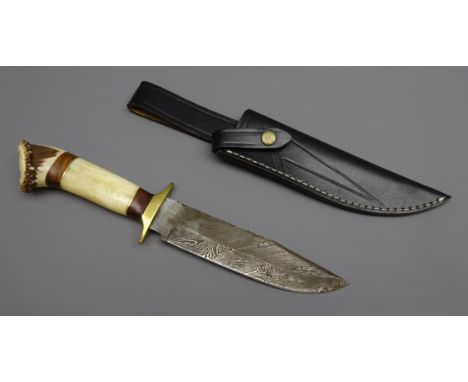 Hunting knife, 19cm Damascus decorated single edge steel blade with brass cross, shaped wood and antler grip, L34cm in stitch