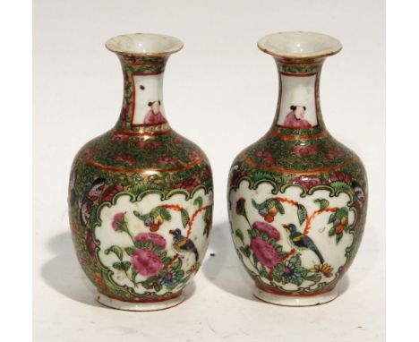PAIR OF CHINESE FAMILLE ROSE PORCELAIN SMALL VASES, each of footed baluster form with waisted neck, painted with panels depic