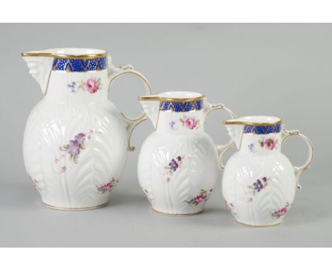 GRADUATED SET OF THREE MODERN COALPORT 'CAUGHLEY MASK-HEAD JUGS', 7 1/2", 5 3/4" AND 5" (19.1cm, 14.6cm and 12.7cm) high, pri