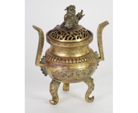 CHINESE GILT METAL TWO HANDLED KORO AND COVER with Dog of Fo finial to the foliate pierced cover and mask capped scroll suppo