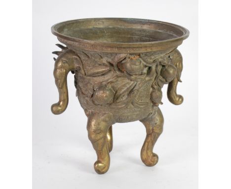 CHINESE GILT BRASS KORO ON INVERTED BELL FORM with two elephant mask handles and conforming scroll supports, cast with flower