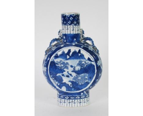 NINETEENTH CENTURY CHINESE BLUE AND WHITE PORCELAIN MOON FLASK, painted with trees and dwellings in mountainous river landsca