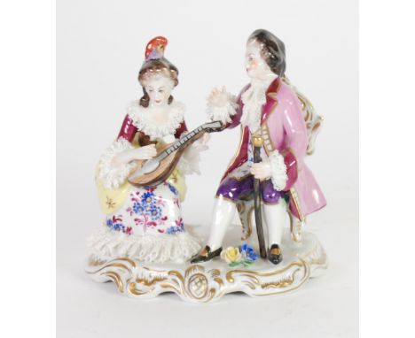 GERMAN LACE PORCELAIN GROUP, modelled as a courtier and a lady playing a mandolin, on a gilt scroll shaped oval base, 4 1/2" 