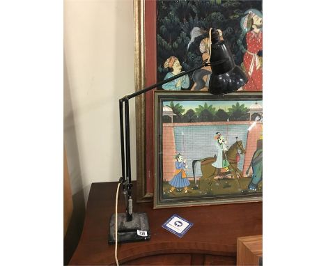A black anglepoise lamp.