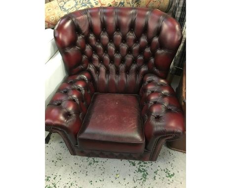 A single button back leather tub chair