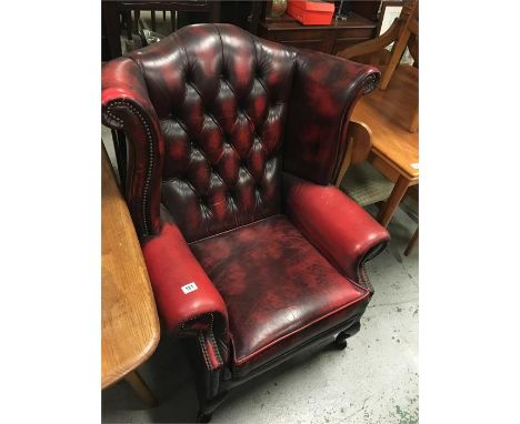 A leather, button back wingback chair