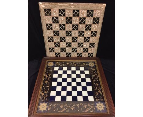 Two attractive chess boards.  One of cut and coloured glass in a wooden frame, and one in a Moorish style mosaic.