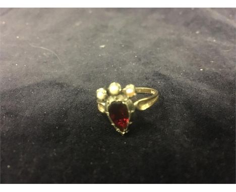 A ruby and seed pearl ring in a 9ct gold setting