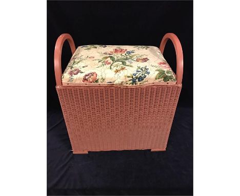 A pink Lloyd Loom stool/hamper