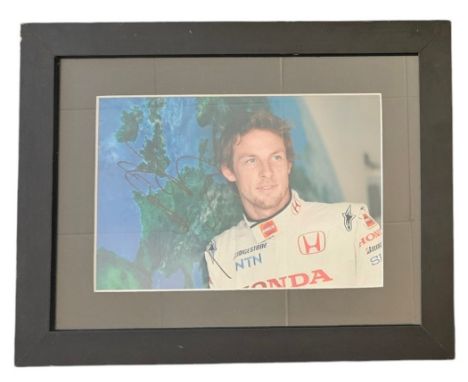 Jenson Button MBE signed photo in racing overalls, framed measures 16 inch by 13 inch appx. Good condition. All autographs co
