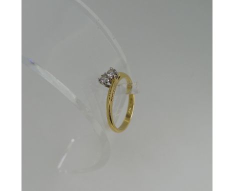 A two stone diamond Ring, set on the cross in 18ct yellow and white gold, each stone approx 0.075ct, Size K, approx total wei