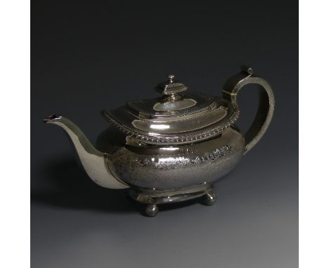 A George IV silver Teapot, hallmarked London, 1821, of oval form with gadrooned rim, raised on ball feet, the hollow handle w