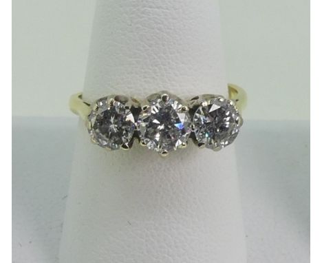 A three stone Diamond Ring, the circular cut centre stone approx 0.56ct, with&nbsp; a circular cut stone on either side, each