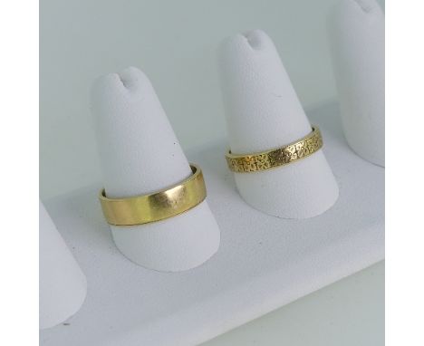 An 18ct yellow gold Band, with foliate engraved decoration, Size R½, together with a plain 18ct yellow gold band, Size T, app