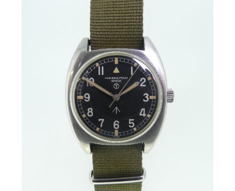 A Hamilton Geneve British Military RAF issue stainless steel gentleman's Wristwatch, circa 1974, the black dial with Military
