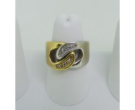 An 18ct yellow and white gold Ring, the front formed of two interlocked open loops each set with three diamond points, marked