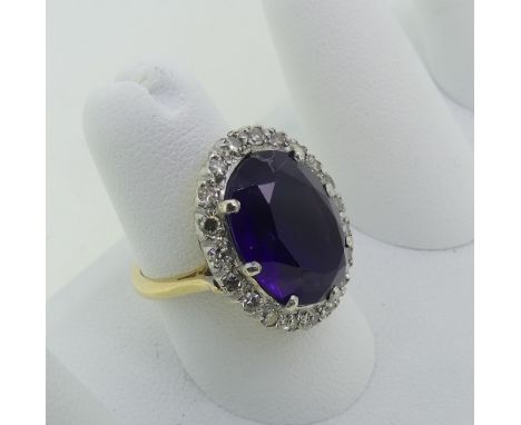 An amethyst and diamond Dress Ring, the oval facetted amethyst surrounded by twenty small diamond points, all mounted in 18ct