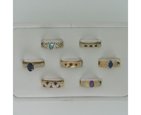 A small amethyst Ring, collet set in 9ct gold, Size M, together with three other 9ct gold rings, variously set including sapp