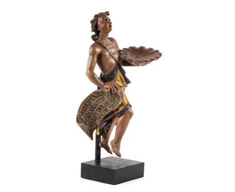 A carved and polychrome painted figure of an angel,18th century, possibly South European,The draped figure holding a shell-sh
