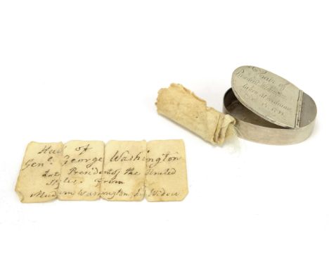 An engraved silver box containing a lock of hair and a hand-written note stating that the lock of hair was taken from the bod